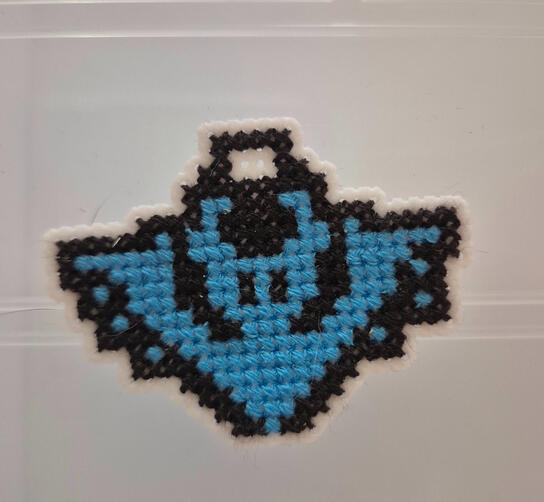 Cross Stitched Bat Keychain A cross stitched neon bat keychain that glows under black lights
